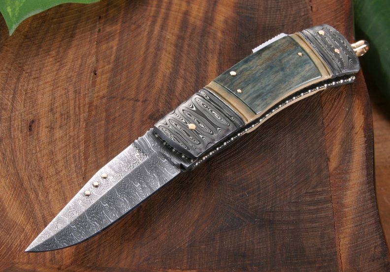 Kaj_Embretsen_Custom_Knives_Fossil_Blue_Damascus_Mammoth__Gold_Folding_Knife.jpg